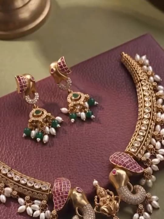 Kundan necklace and matching earrings with pearl and emerald drops